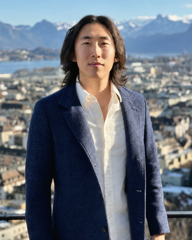 Chen Li in front of a mountain cityscape